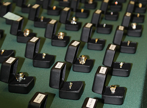 Rows of class rings on a table