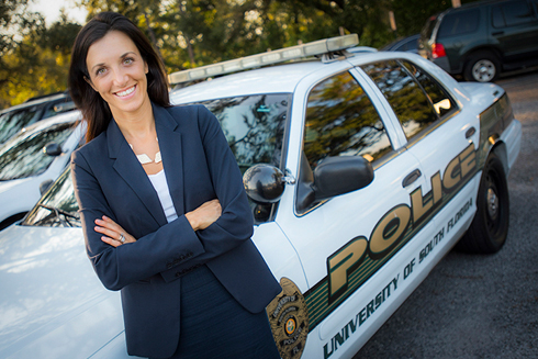 Dr. Bryanna Fox in front of a ֱ police car.
