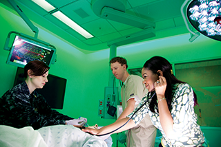 Nursing students work in sim lab
