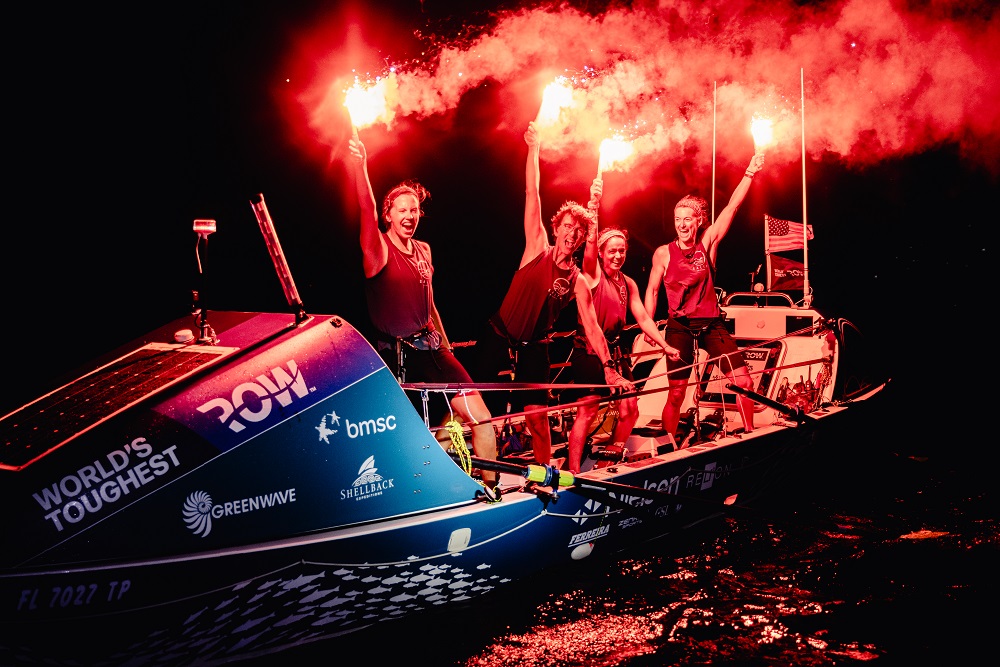 ֱ team, Salty Science, holding flares in celebration of their successful finish of the World’s Toughest Row-Atlantic race